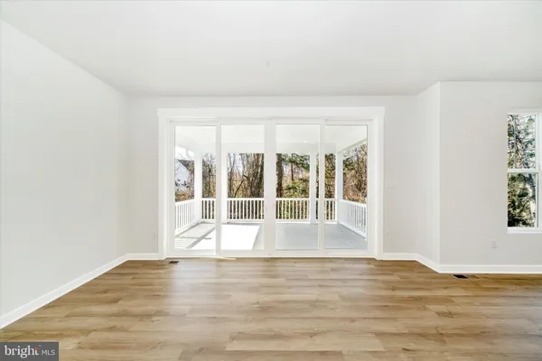 a view of a porch with wooden floor and fence