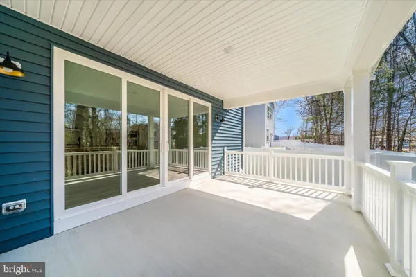 a view of a porch with wooden floor and fence