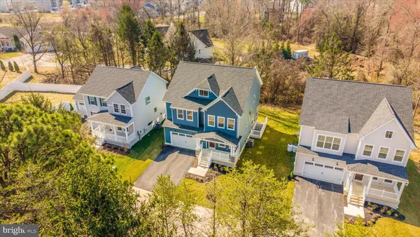 an aerial view of a house with swimming pool and porch