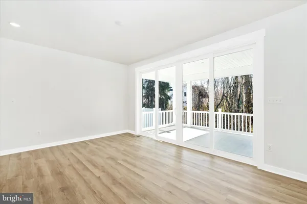 a living room with furniture a fireplace and a floor to ceiling window