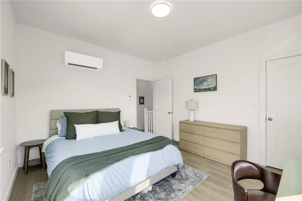 1070 Dill Avenue Southwest, Unit 204 Atlanta, GA 30310 - Photo 12 of 17 a bedroom with a bed and chair