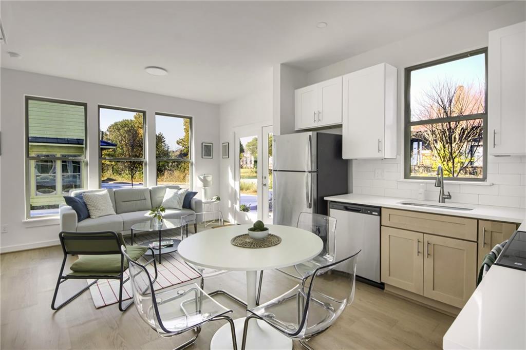 1070 Dill Avenue Southwest, Unit 204 Atlanta, GA 30310 - Photo 8 of 17 a kitchen with a dining table and chairs