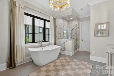 a spacious bathroom with a bathtub and window