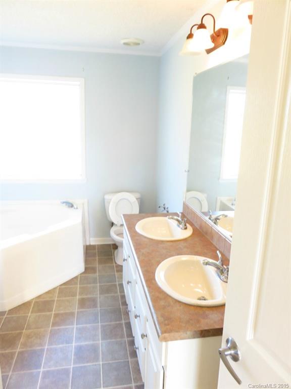 1028 Tot Dellinger Road Cherryville, NC 28021 - Photo 20 of 21 a bathroom with a sink a toilet and a mirror