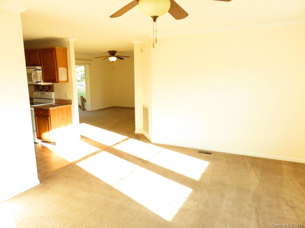 1028 Tot Dellinger Road Cherryville, NC 28021 - Photo 10 of 21 a view of a kitchen with kitchen island a sink wooden floor and a living room view