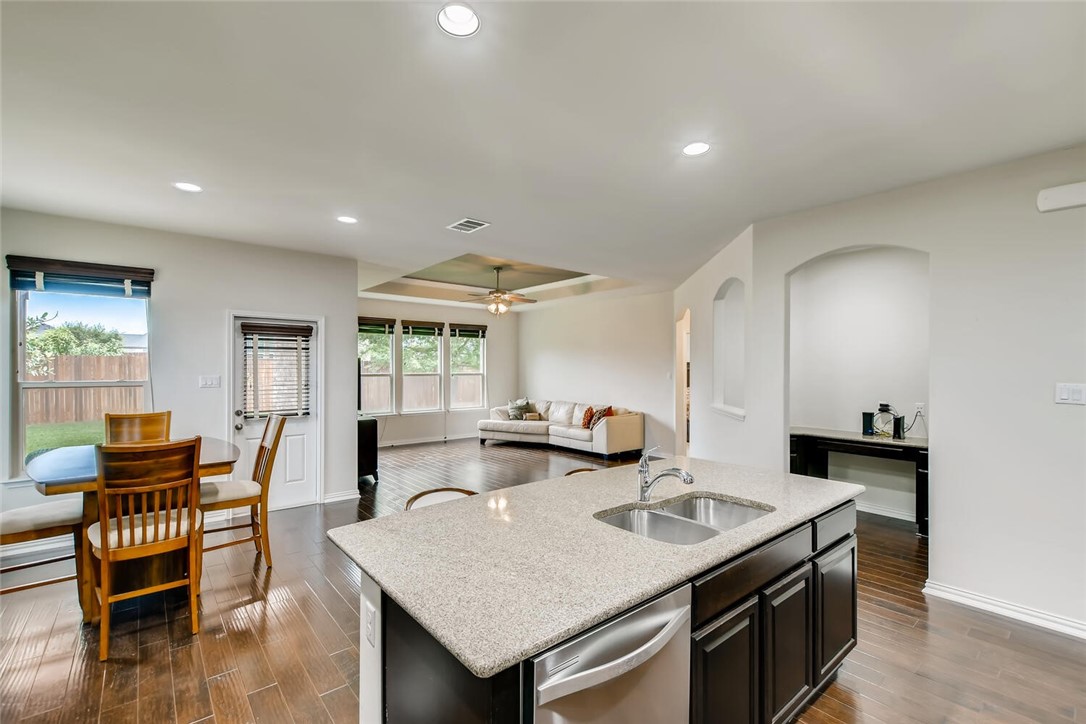 a kitchen with granite countertop a sink and a stove
