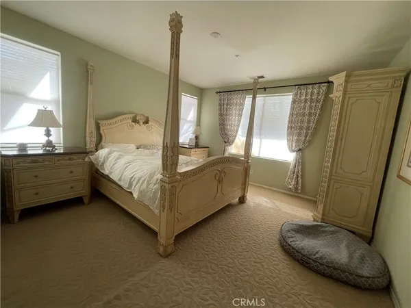 a bedroom with a bed and a chair