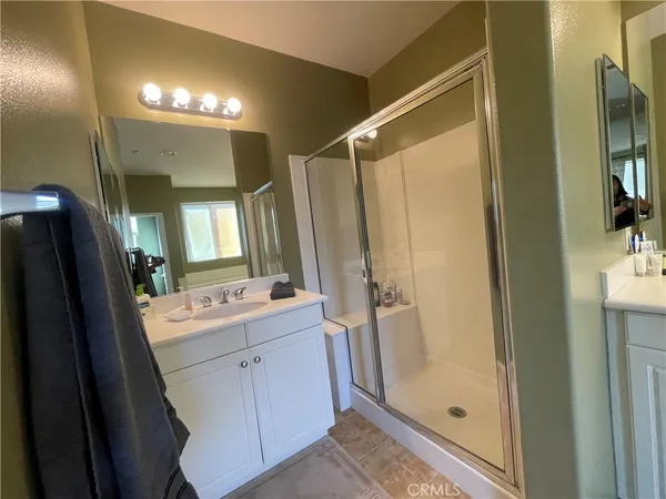 a bathroom with a tub sink and mirror