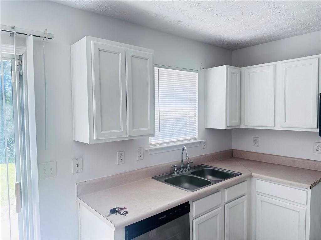 9432 Lakeview Road Union City, GA 30291 - Photo 3 of 11 a kitchen with stainless steel appliances granite countertop a sink and a white cabinets