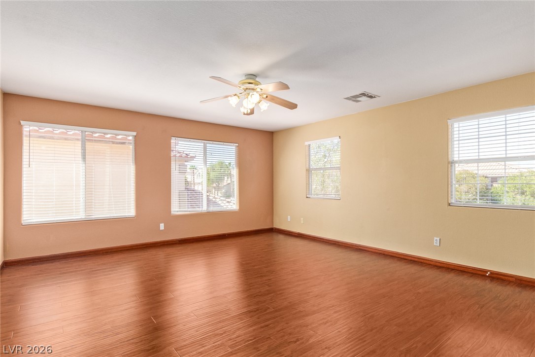 1477 Rancho Ridge Drive Henderson, NV 89012 - Photo 27 of 46 Rich hardwood floors complement neutral walls in this spacious, naturally illuminated room.