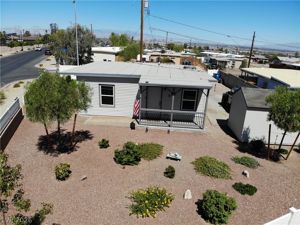 116 West Basic Road Henderson, NV 89015 - Photo 34 of 39 A well-maintained single-story residence boasts a covered front porch and a low-maintenance gravel yard with mature desert landscaping.