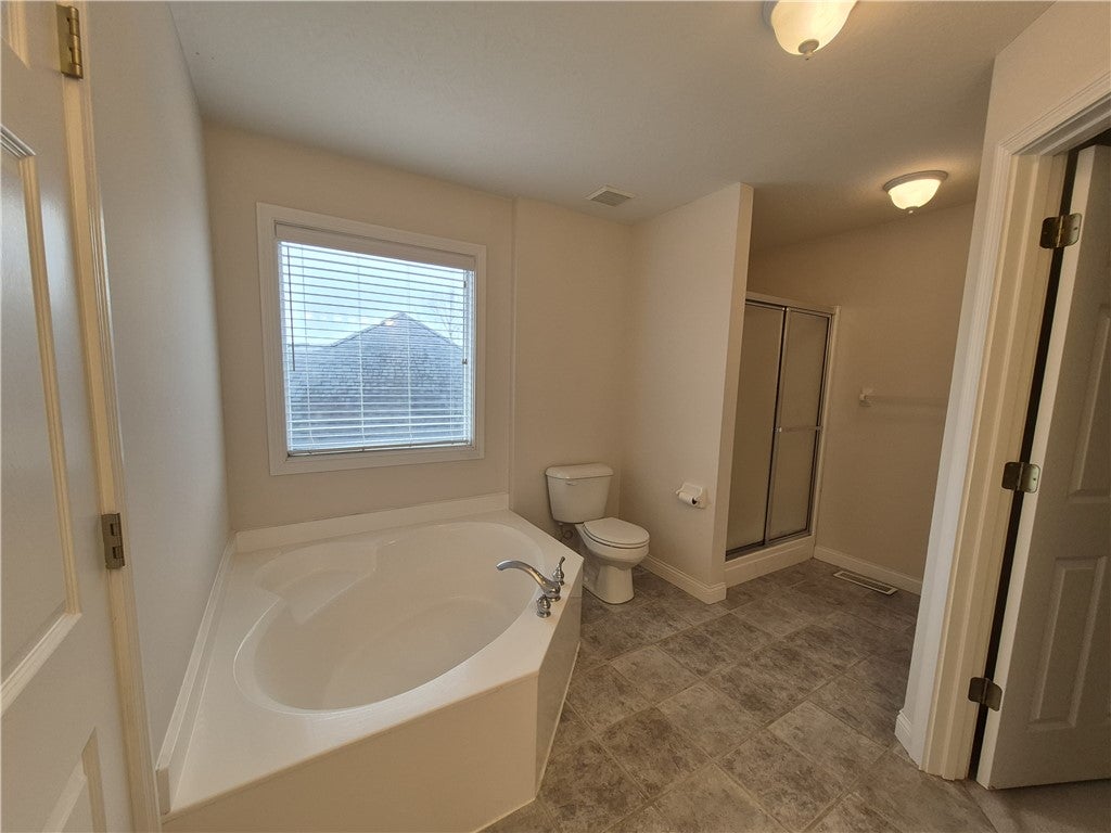 633 Orient Way Hamilton, OH 45013 - Photo 51 of 68 This spacious bathroom offers a relaxing soaking tub and convenient shower.