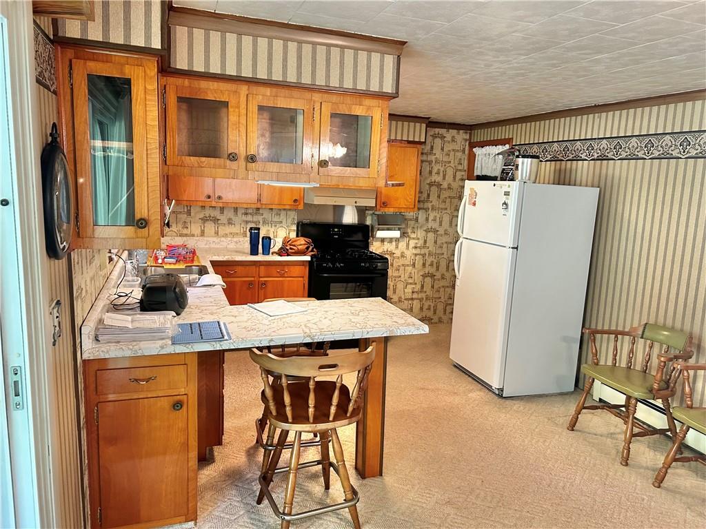 562 Smith Run Road Amity, PA 15311 - Photo 11 of 26 a kitchen with a refrigerator a stove and a dining table