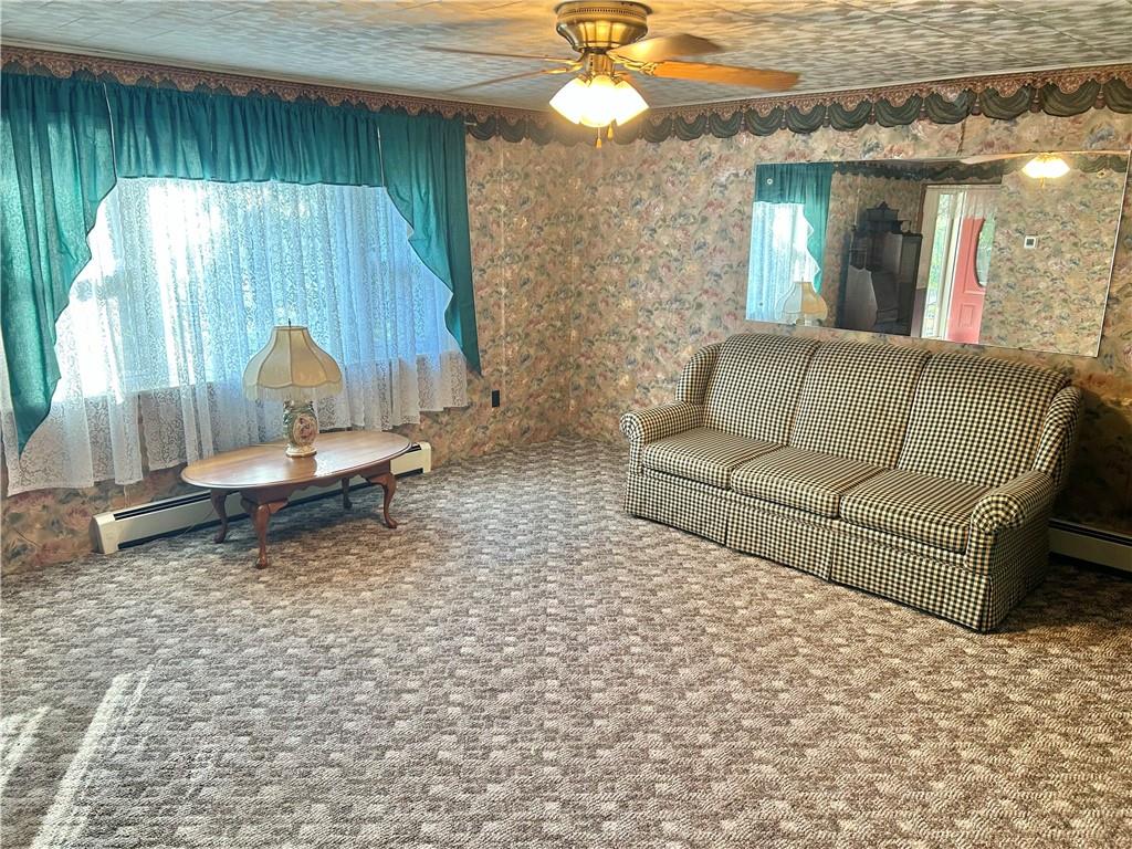 562 Smith Run Road Amity, PA 15311 - Photo 12 of 26 a living room with furniture and a chandelier