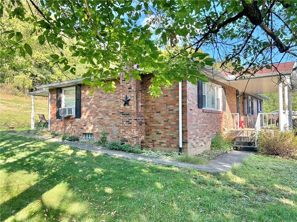 562 Smith Run Road Amity, PA 15311 - Photo 3 of 26 front view of a house with a tree