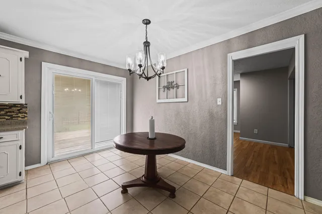 a view of a hallway to a livingroom with furniture