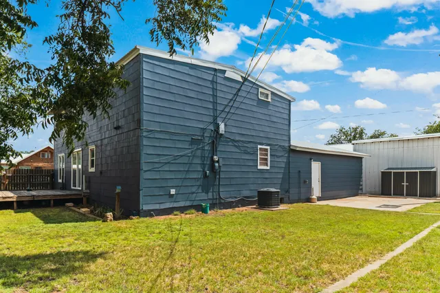 a house view with swimming pool in front of it