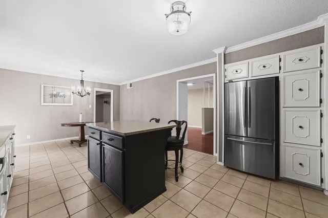 a kitchen with stainless steel appliances a refrigerator and a stove top oven