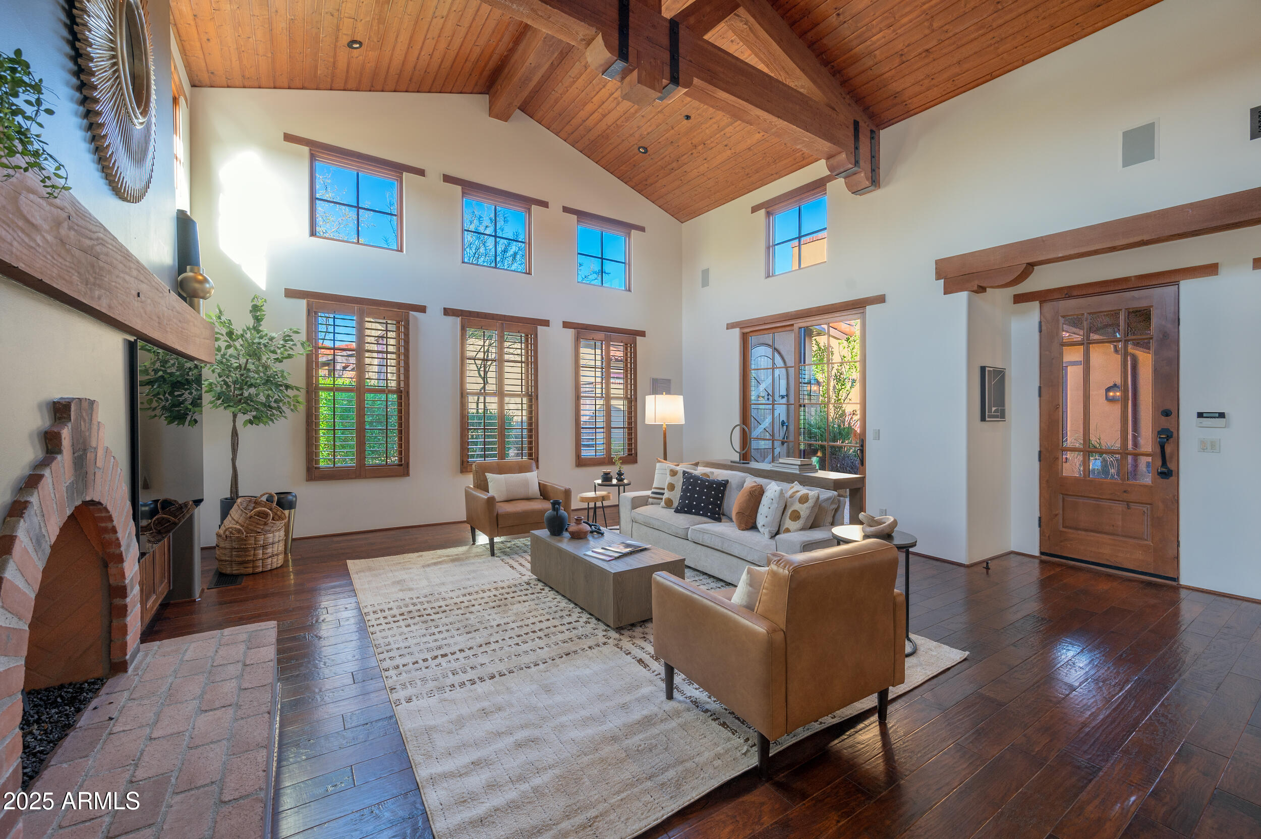 10575 East Rising Sun Drive Scottsdale, AZ 85262 - Photo 11 of 48 a living room with furniture wooden floor and a fireplace