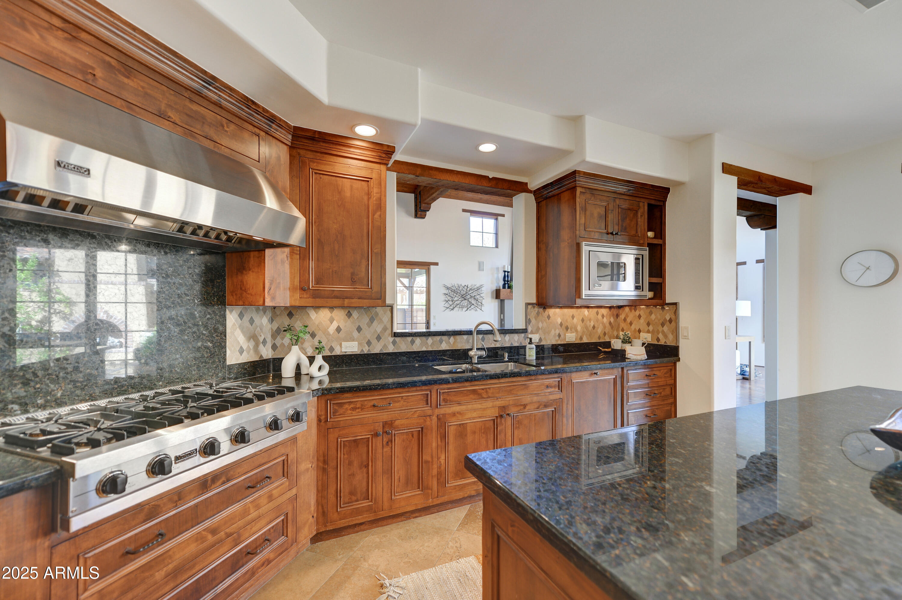10575 East Rising Sun Drive Scottsdale, AZ 85262 - Photo 17 of 48 a kitchen with stainless steel appliances granite countertop a stove a sink and a granite counter tops
