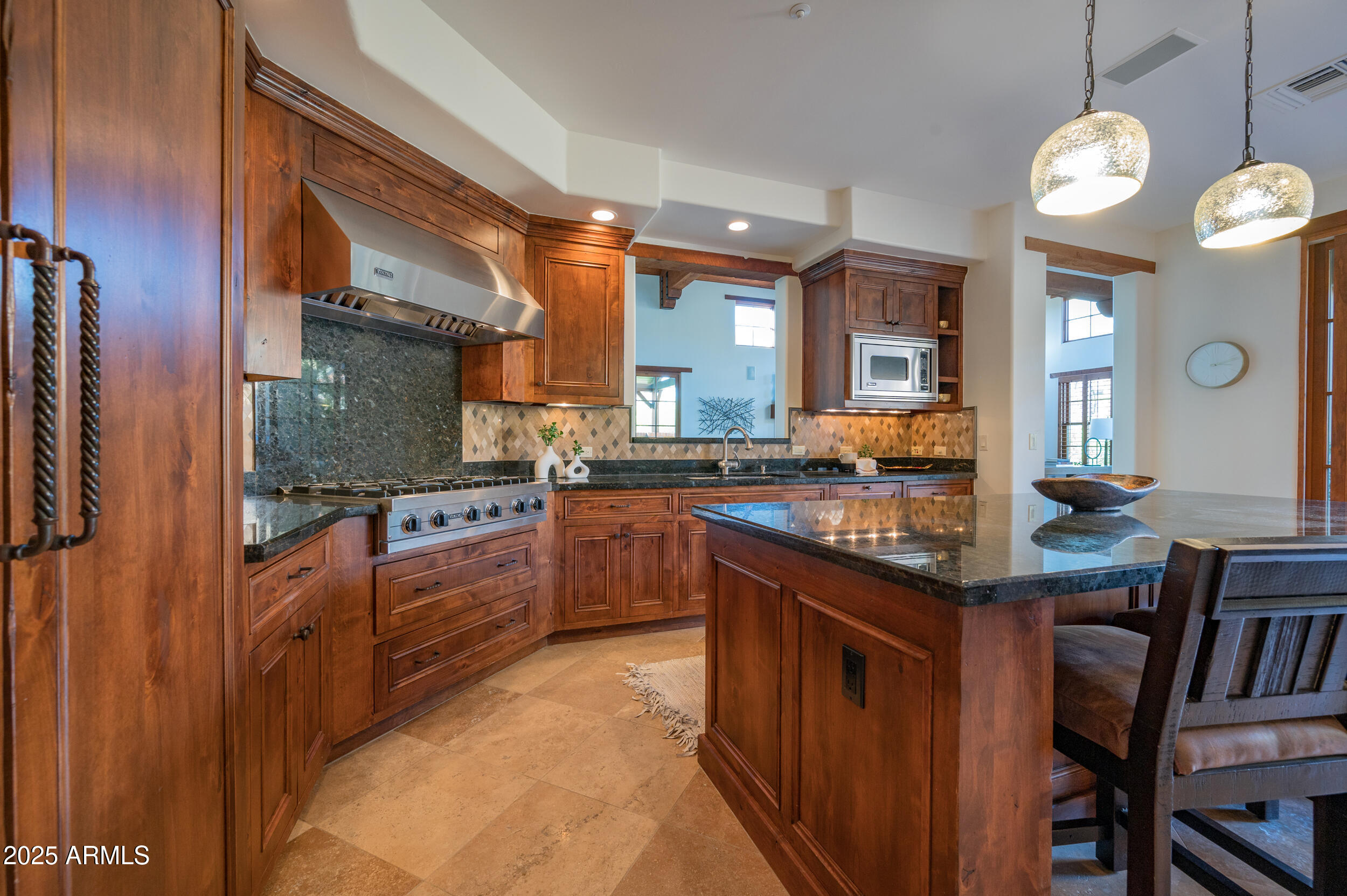 10575 East Rising Sun Drive Scottsdale, AZ 85262 - Photo 18 of 48 a kitchen with stainless steel appliances granite countertop a stove and cabinets