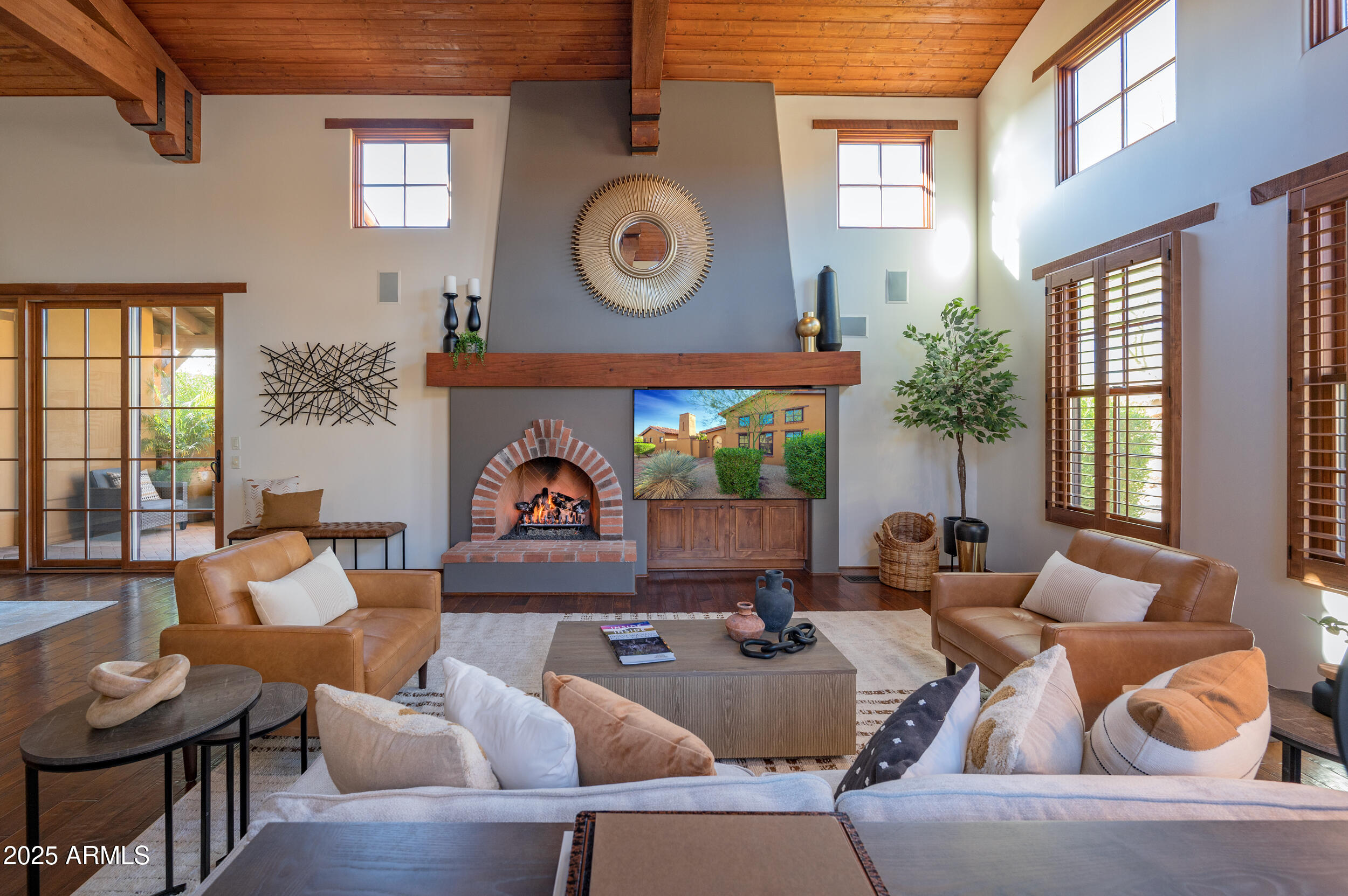 10575 East Rising Sun Drive Scottsdale, AZ 85262 - Photo 9 of 48 a living room with fireplace furniture and a large window