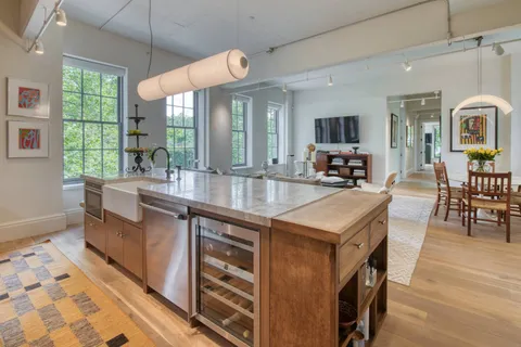 a kitchen with stainless steel appliances granite countertop a stove and a sink