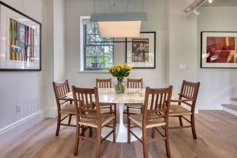 a view of a dining room with furniture wooden floor and a window