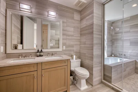 a bathroom with a sink a toilet and shower