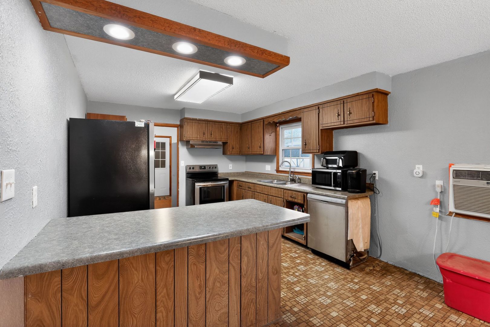 1531 North Charleston Road Salem, IL 62881 - Photo 14 of 34 a kitchen with kitchen island a counter top space a sink stainless steel appliances and cabinets