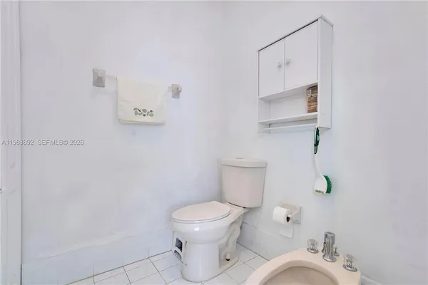 a bathroom with a double vanity sink a large mirror a bathtub and window