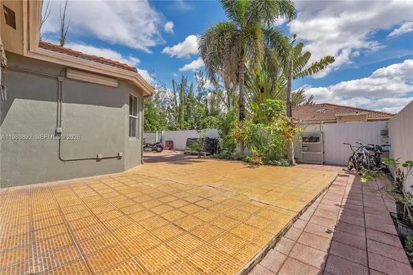 a view of a backyard with sitting area