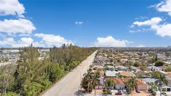 an aerial view of a house with a yard and potted plants