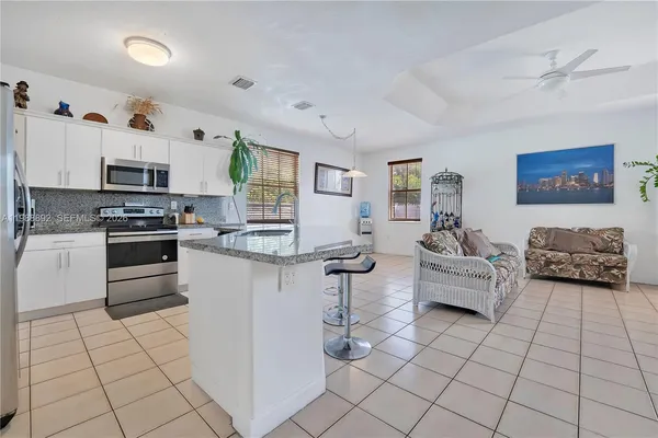 a kitchen with stainless steel appliances cabinets a sink and a stove top oven
