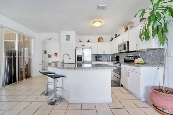 a kitchen with stainless steel appliances a sink and a refrigerator