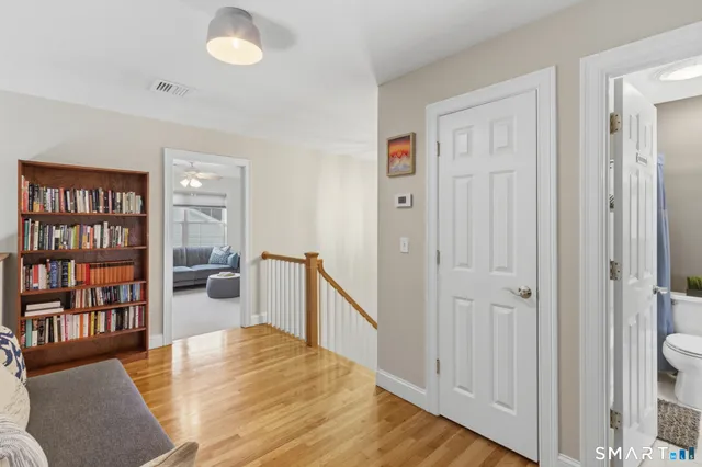 a bedroom with furniture and a book shelf