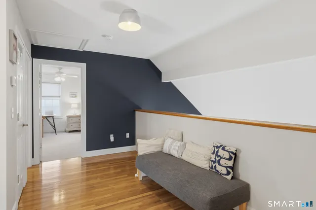 a living room with furniture and view of bathroom
