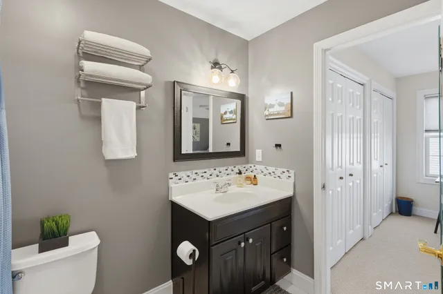 a bathroom with a sink vanity and a mirror