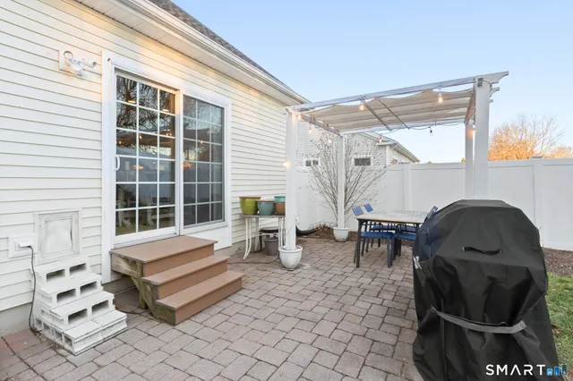a view of a patio with couple of chairs and couch