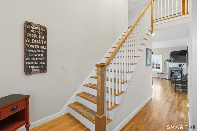 a view of entryway with wooden floor and stairs