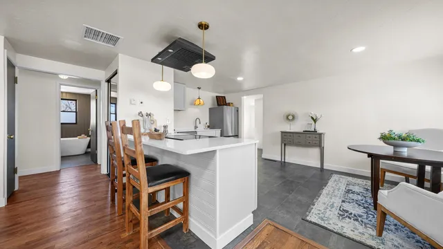 a view of kitchen and dining area with a sink