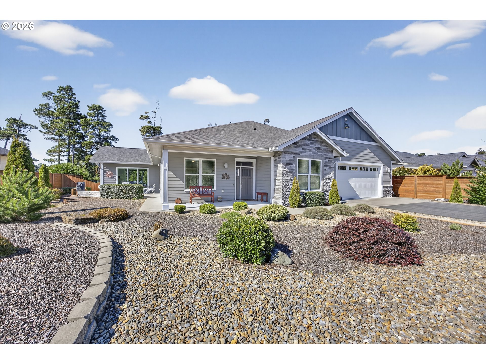 a front view of a house with a yard and potted plants