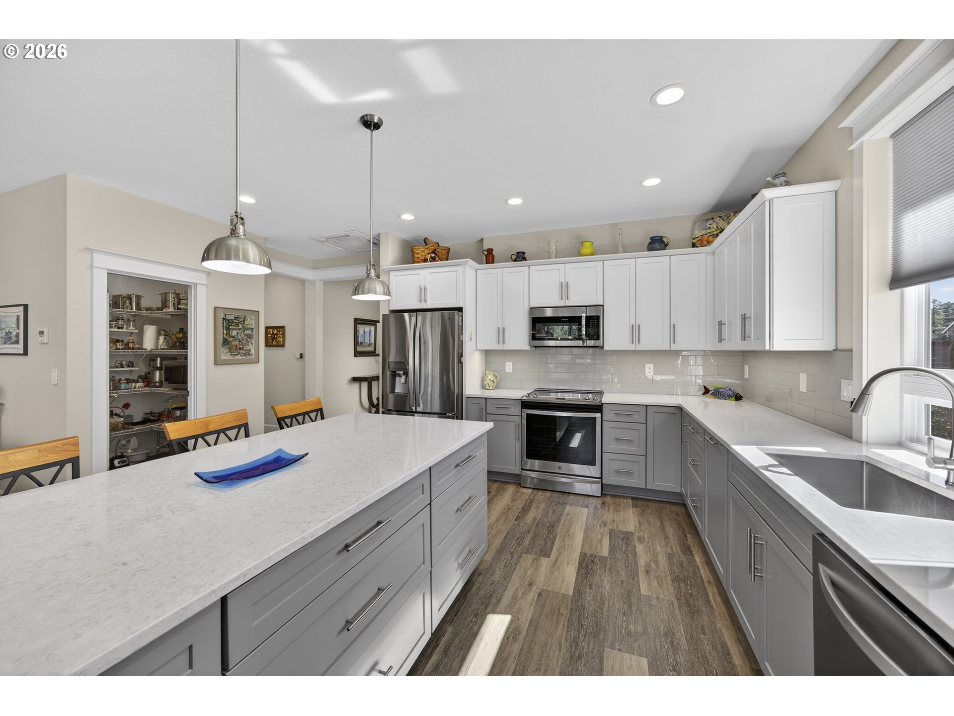 88084 Lake Point Drive Florence, OR 97439 - Photo 14 of 22 a large kitchen with kitchen island a stove a sink a refrigerator and a wooden cabinets
