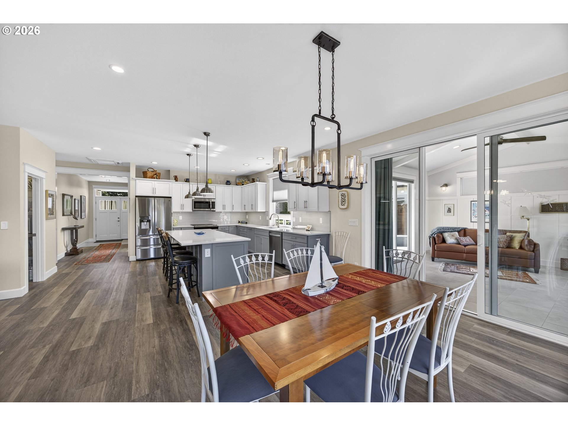 88084 Lake Point Drive Florence, OR 97439 - Photo 15 of 22 a dining room with furniture a chandelier and wooden floor