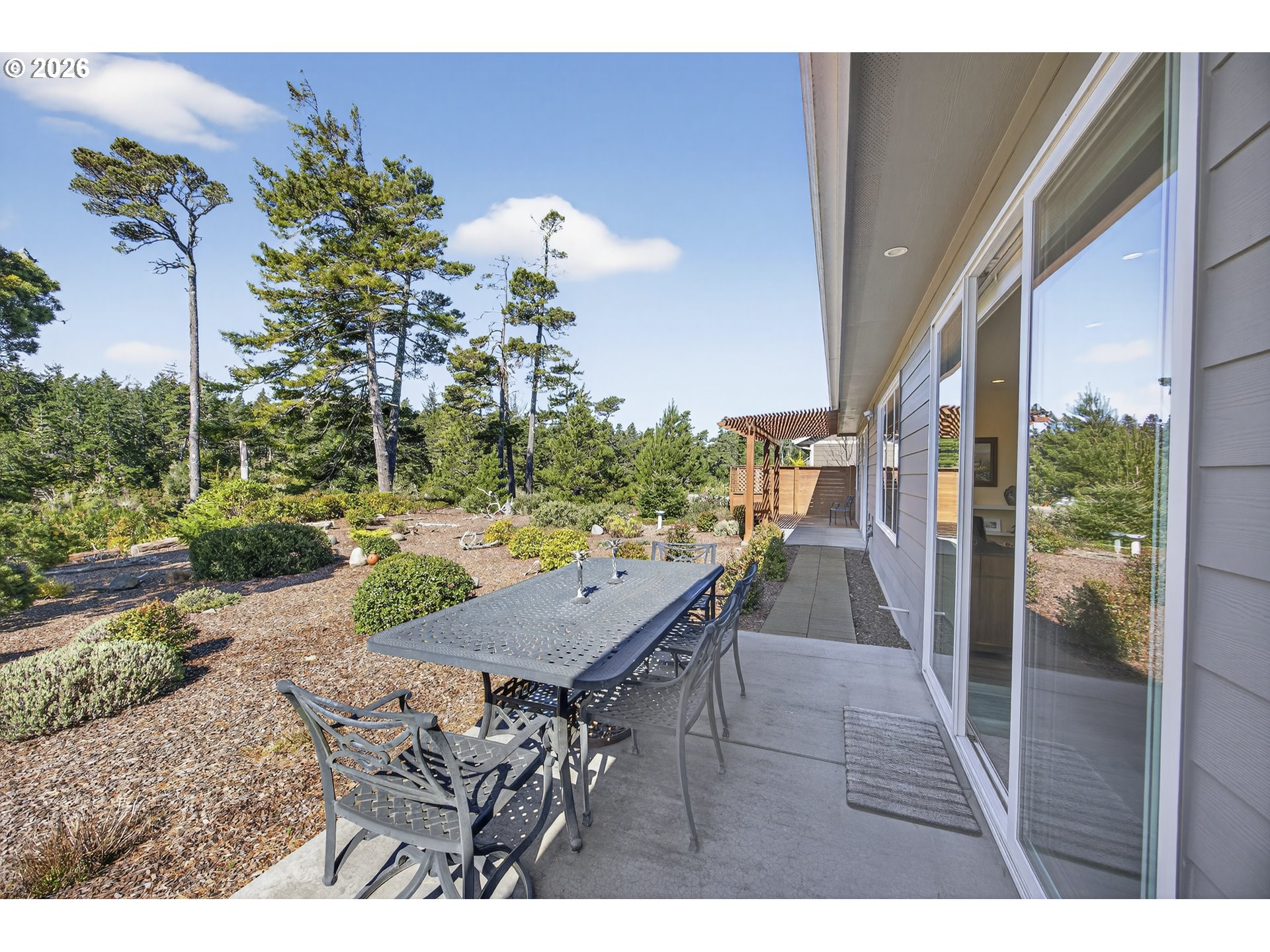 88084 Lake Point Drive Florence, OR 97439 - Photo 6 of 22 a view of a patio with table and chairs