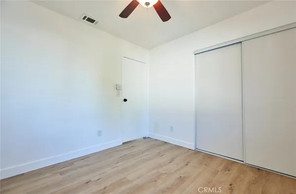an empty room with ceiling fan