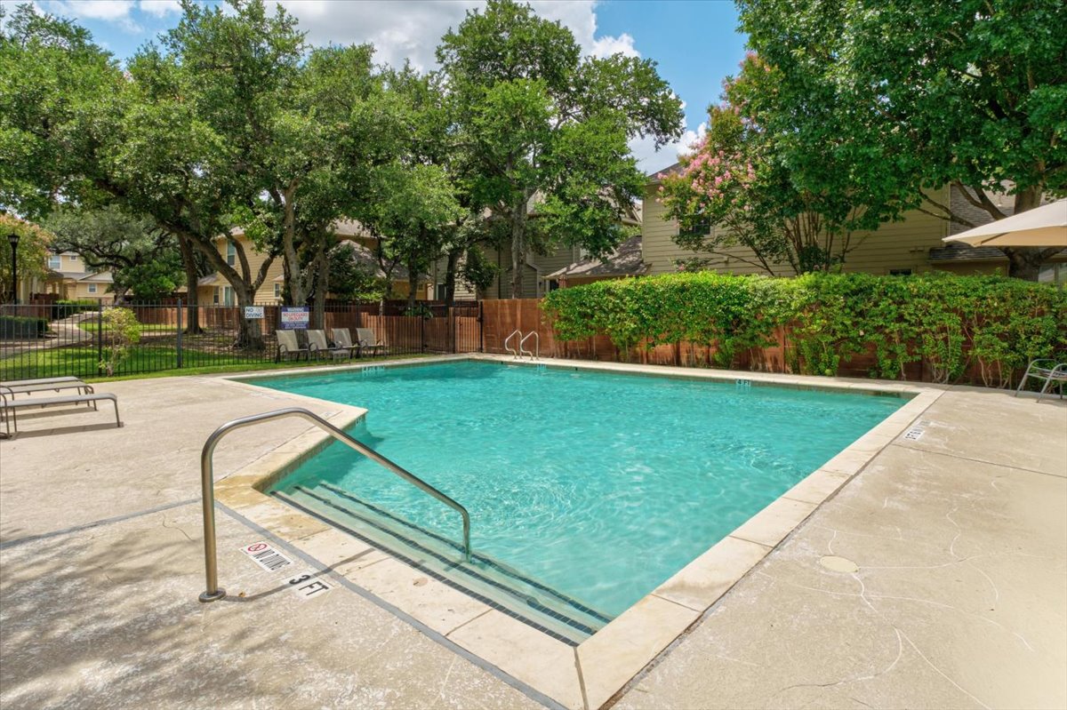 11000 Anderson Mill Road, Unit 11 Austin, TX 78750 - Photo 27 of 34 A sparkling pool invites relaxation, set amidst mature trees and private fencing.
