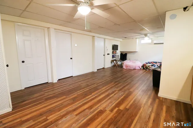 a bedroom with furniture and a wooden floor
