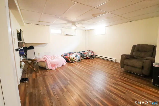 a view of a room with a hanging light and kitchen