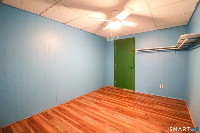 a view of empty room with wooden floor